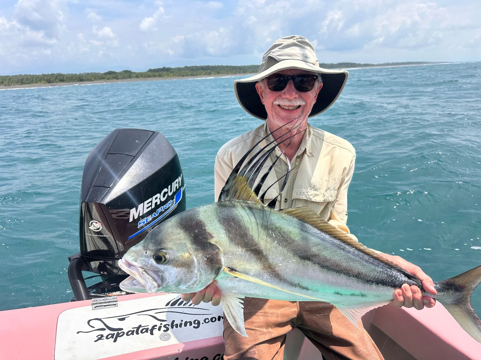 Happy angler holding a trophy roosterfish