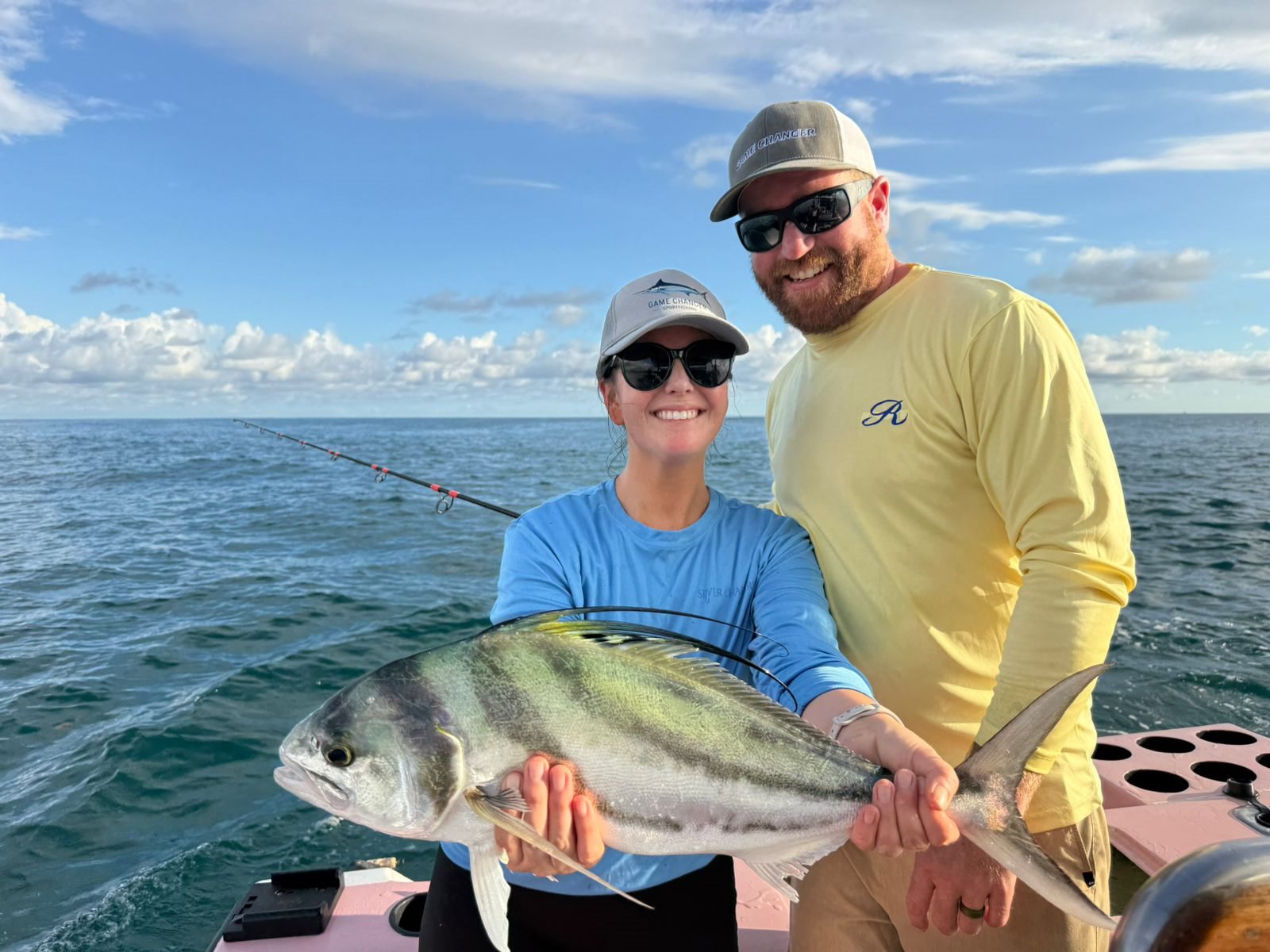 Couple smiling with their catch on a private charter