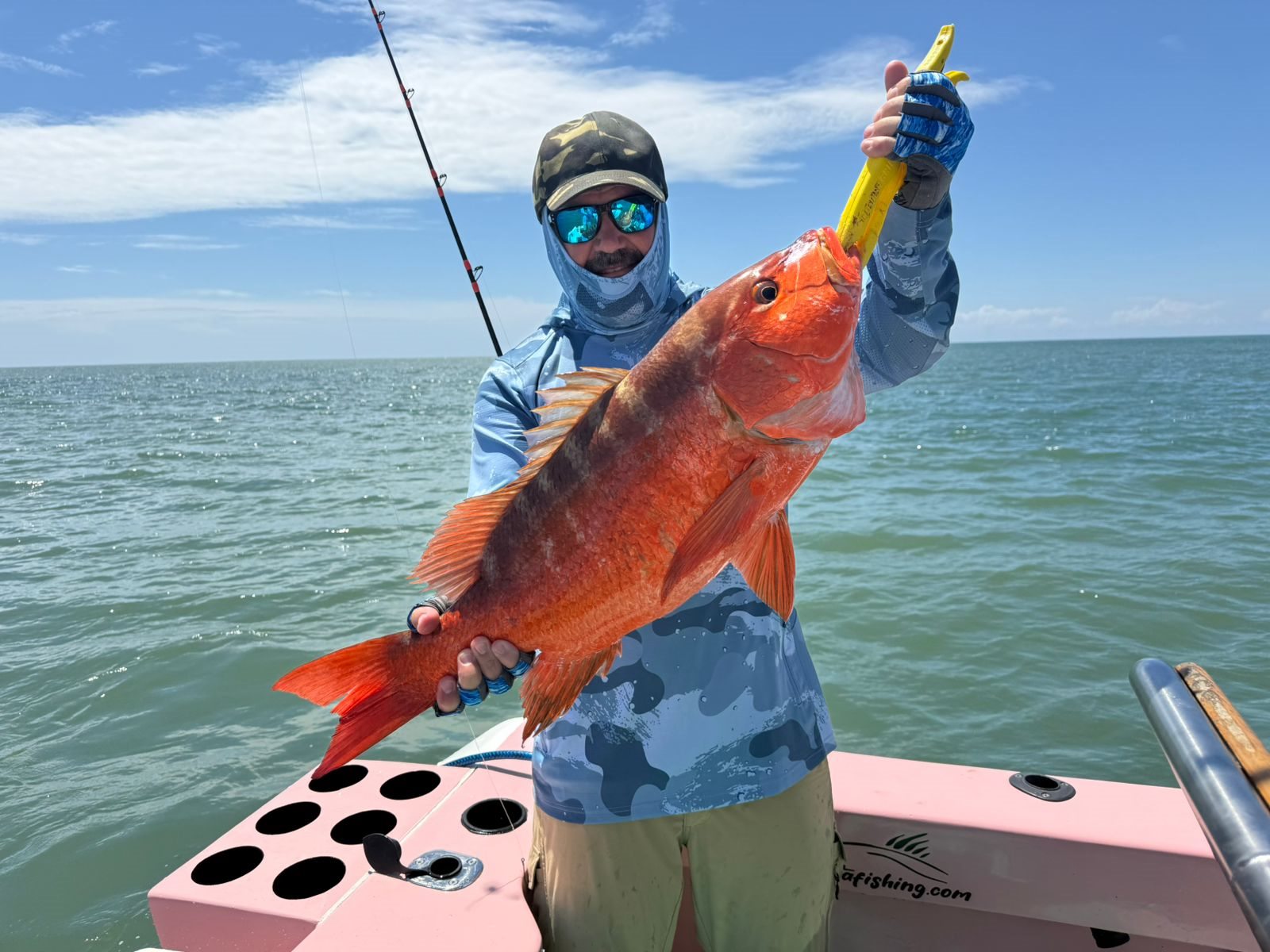 Angler holding a bright red snapper
