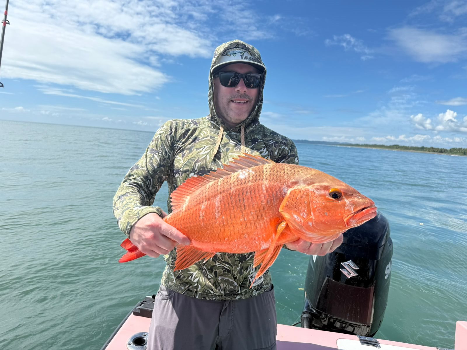 Angler holding a heavy red reef fish
