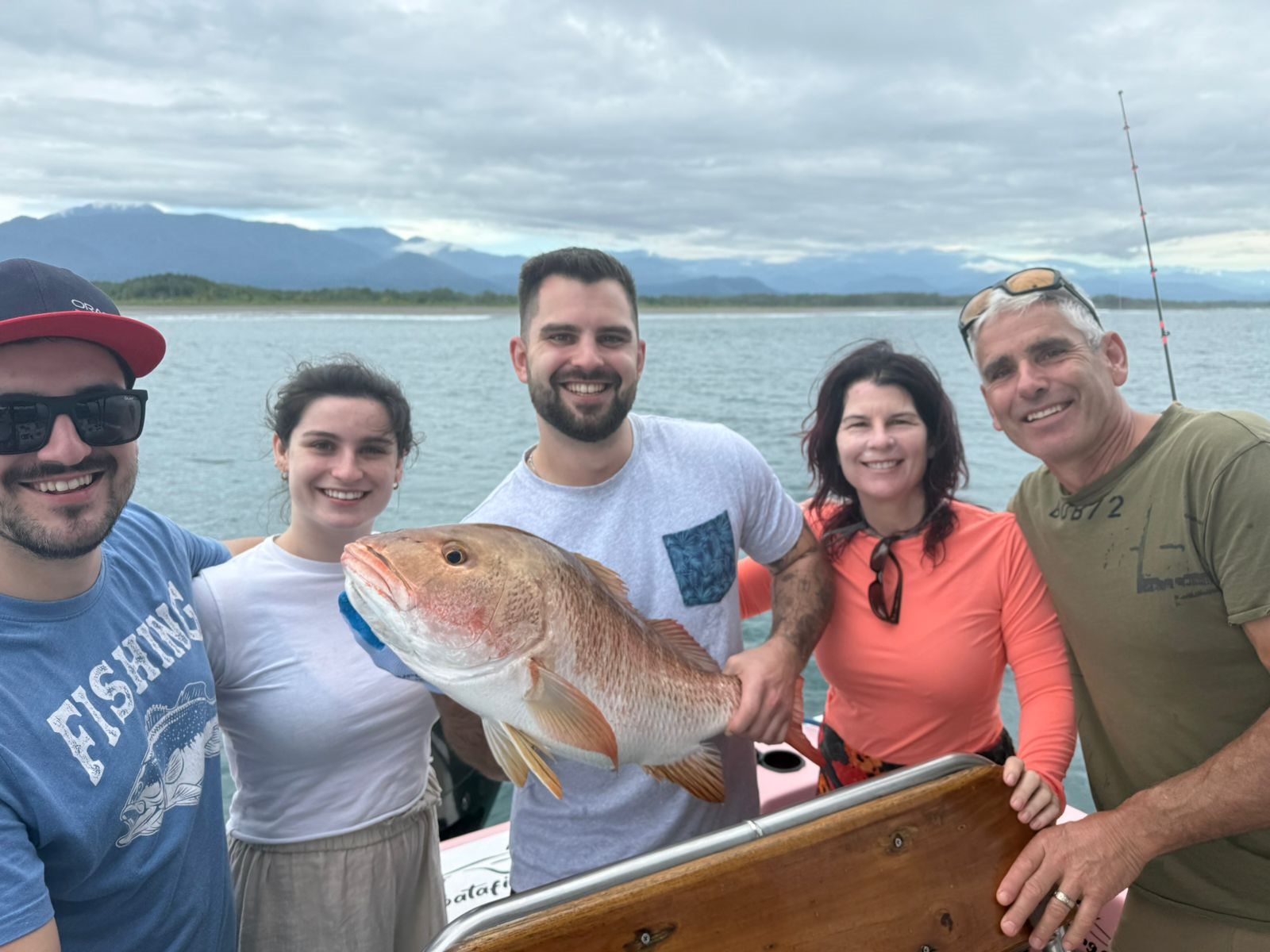 Happy family gathered around their catch