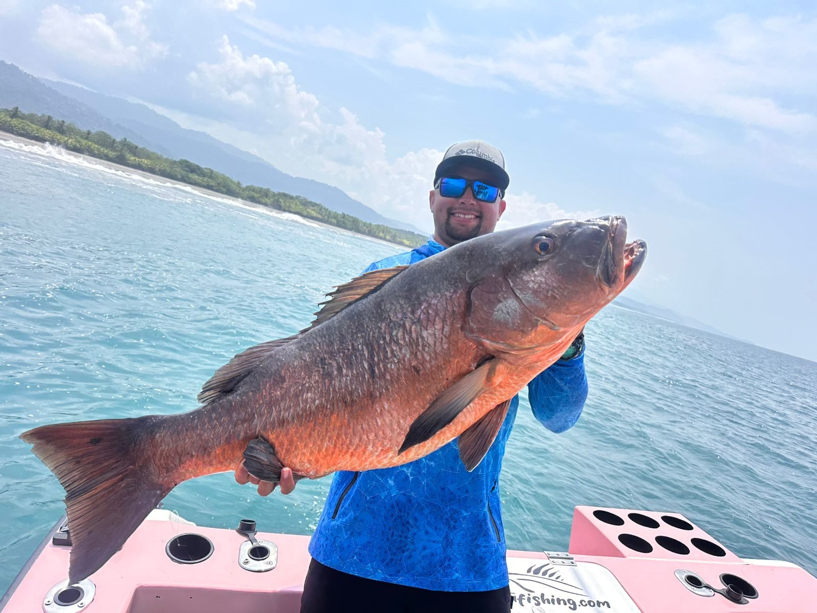 Angler holding a very large dark reef fish