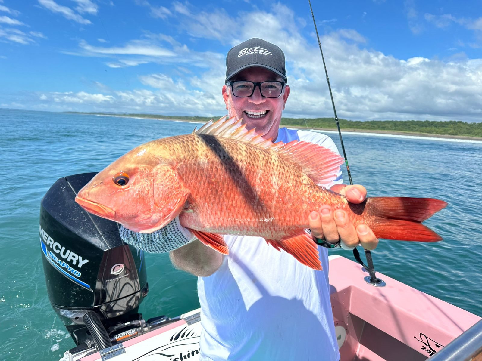 Smiling angler holding a broad red snapper