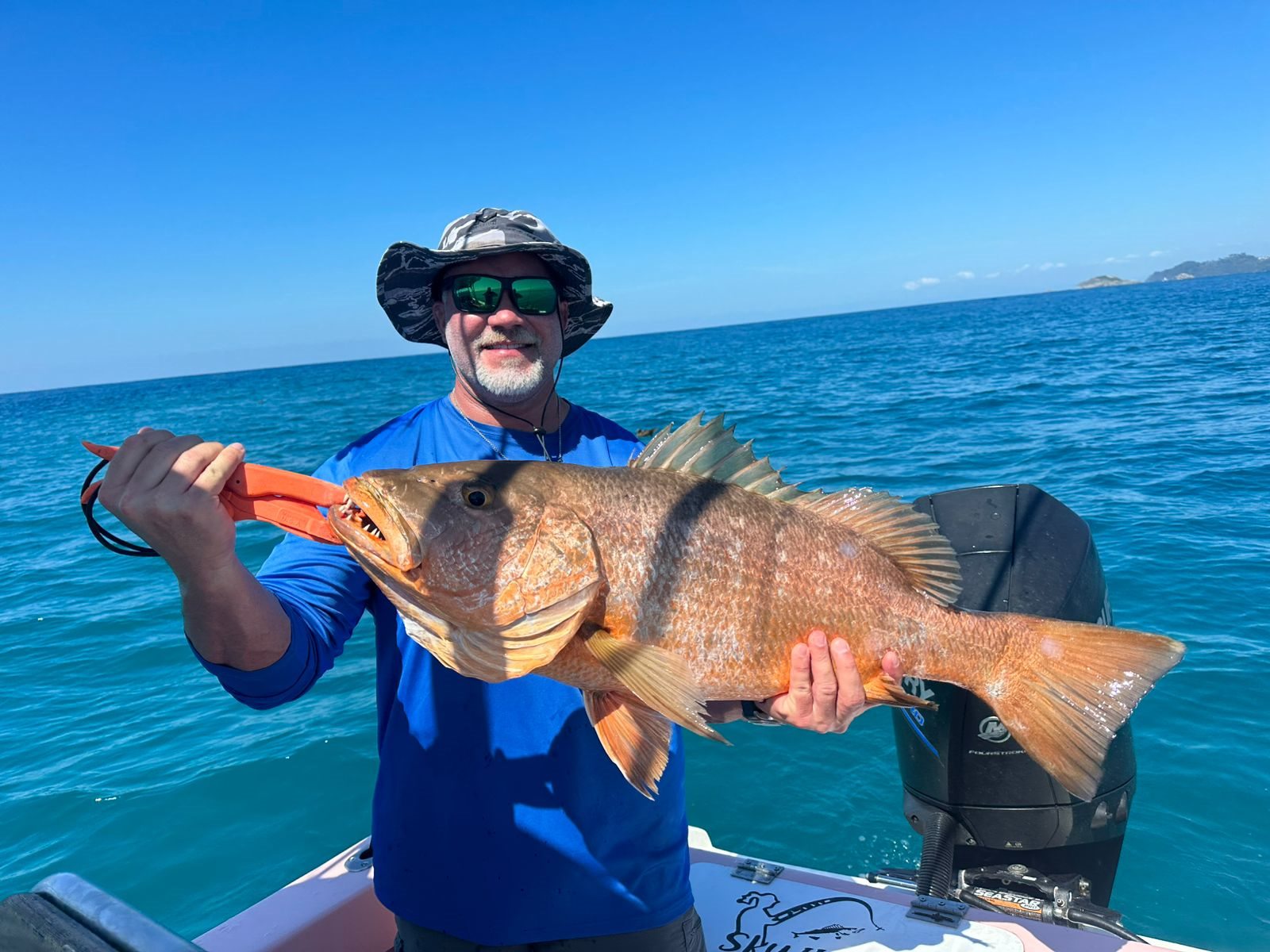 Angler holding a very large golden-brown fish