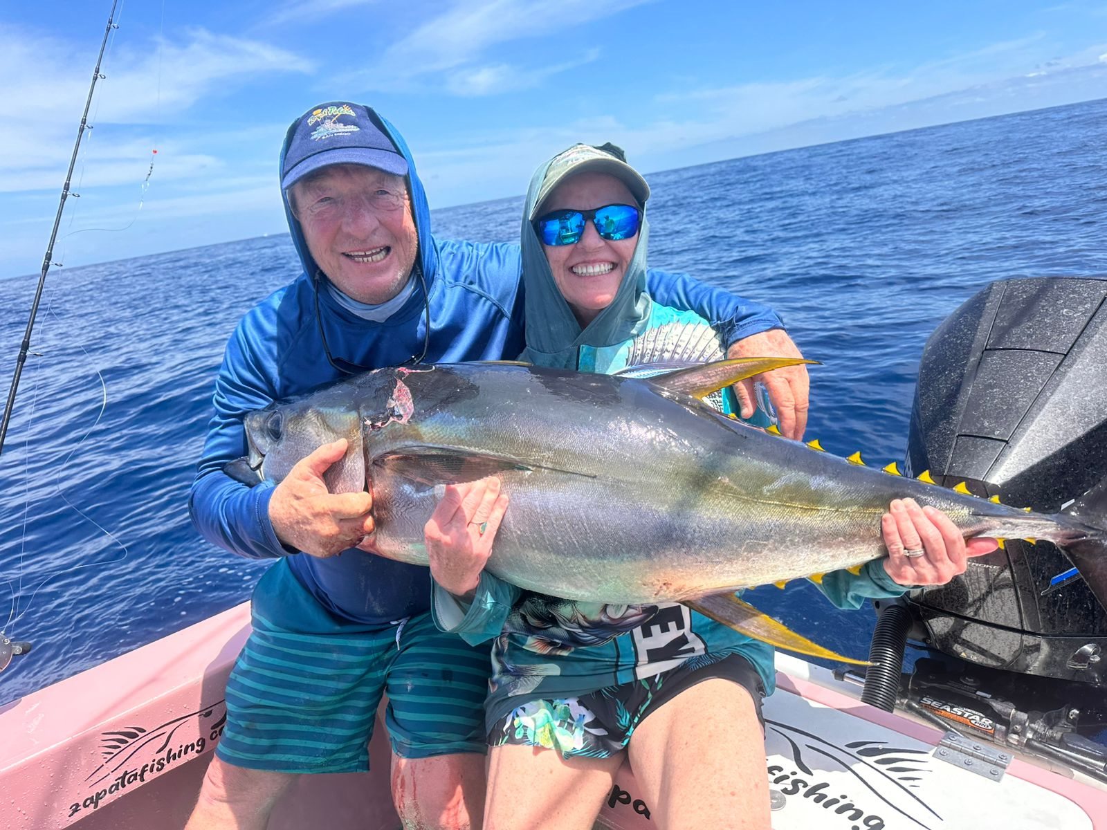 Happy couple displaying a tuna together