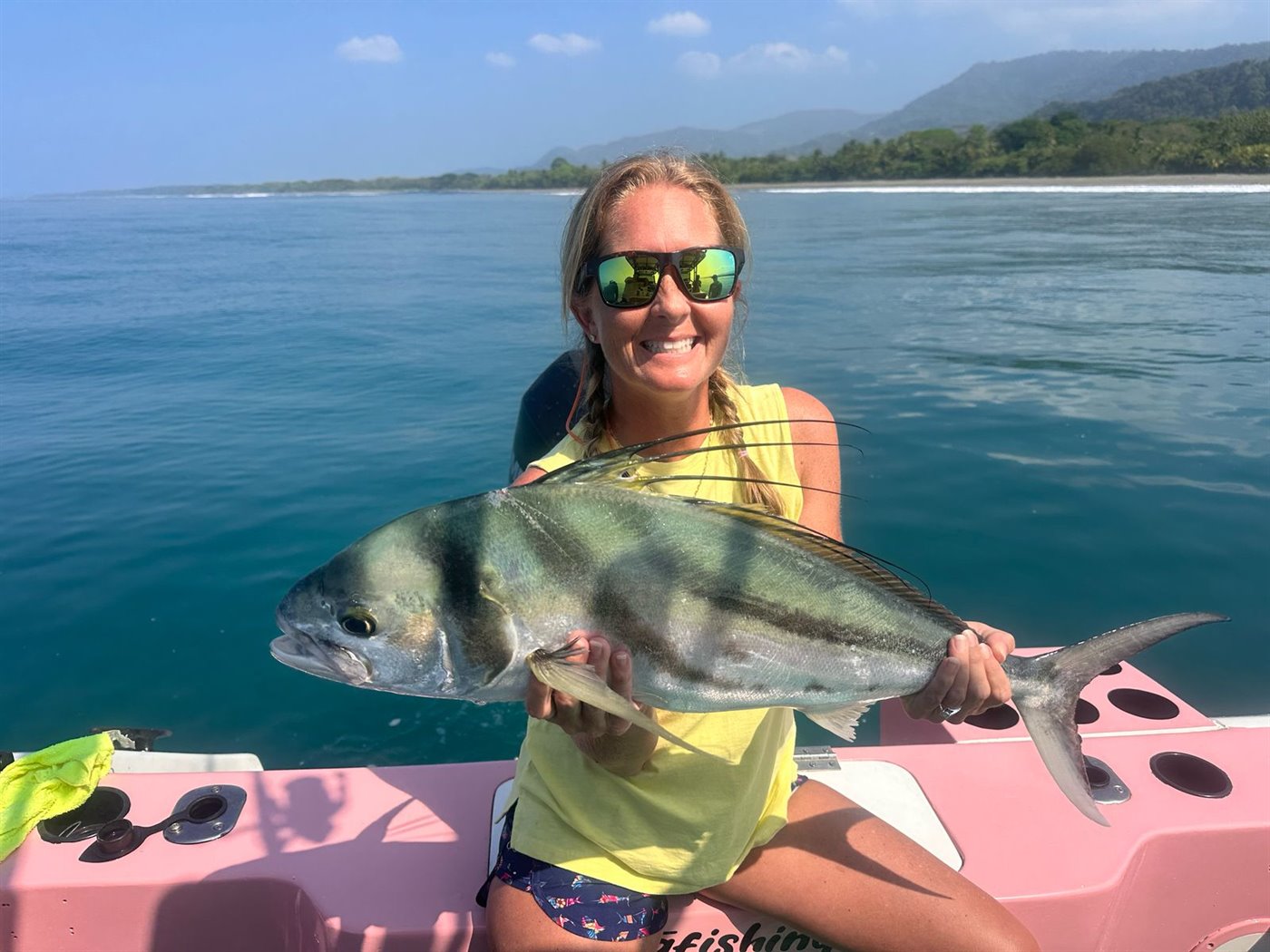 Happy angler holding a roosterfish near Quepos, Costa Rica